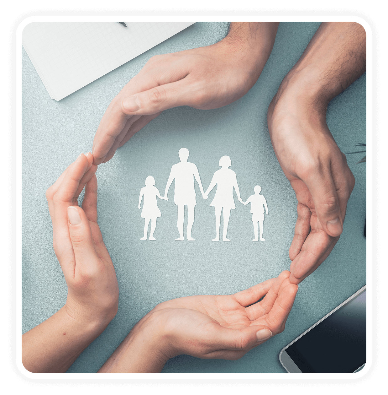Hands forming circle around paper family figures.